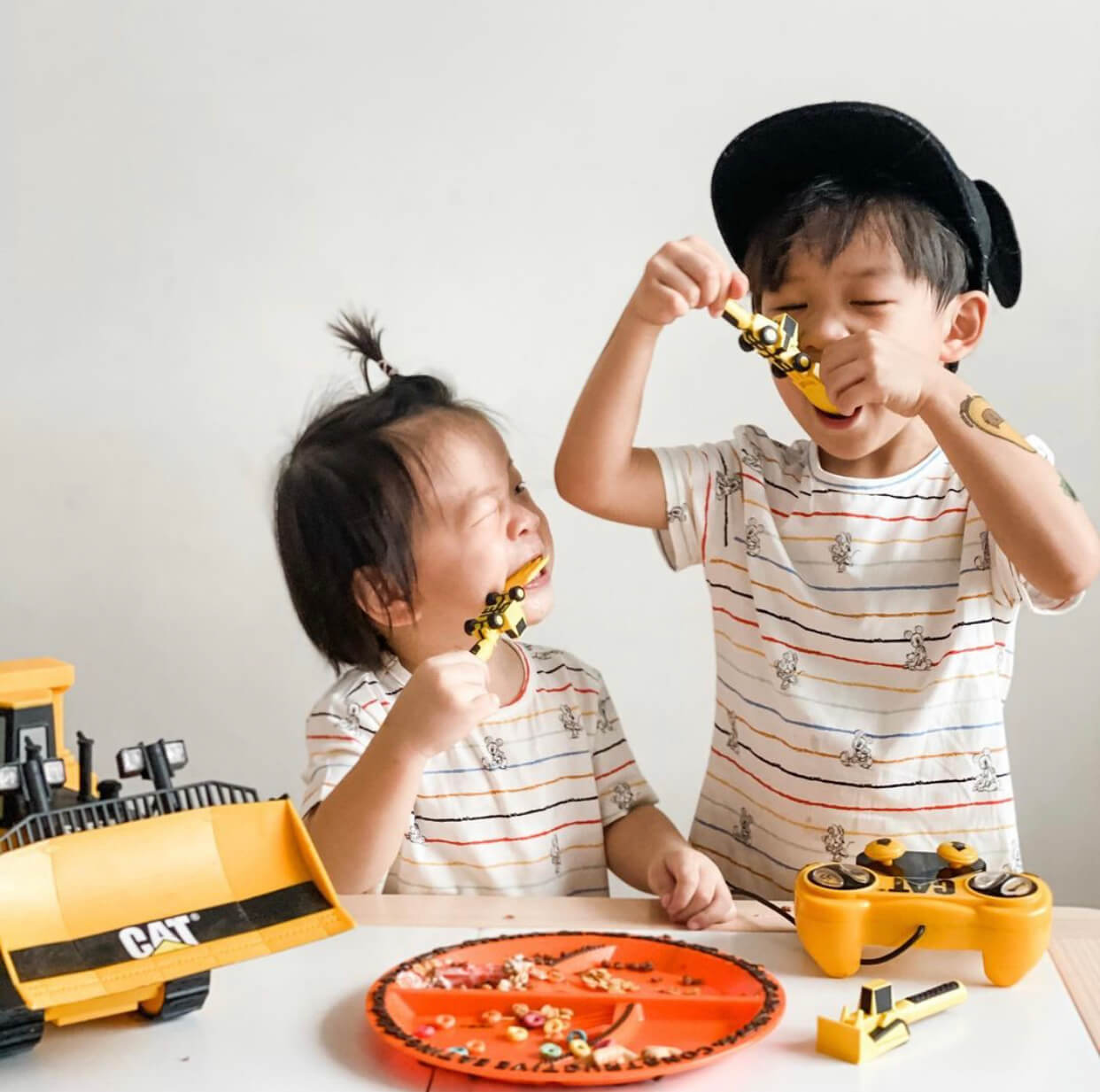 kids enjoying their meal off a construction themed plate