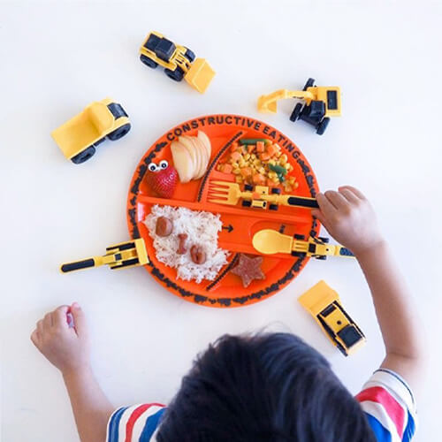 kids eating their food off of a construction themed plate 