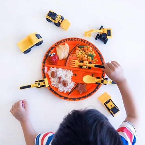kids eating their food off of a construction themed plate 